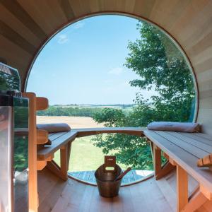a room with a table and a large window at Cabane du Bois des Nauzes in Seyches