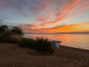 a kite sitting on the beach at sunset at Urban Monkey Summer Camp in Kaji-Say