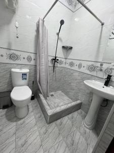 a bathroom with a toilet and a sink at Sobirjon Guest House in Khiva