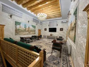 a living room with a couch and a table at Sobirjon Guest House in Khiva