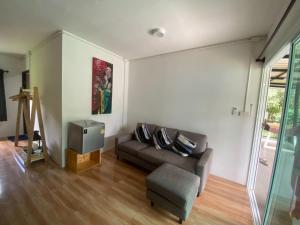 a living room with a couch and a chair at PD RESORT Kohkood in Ko Kut