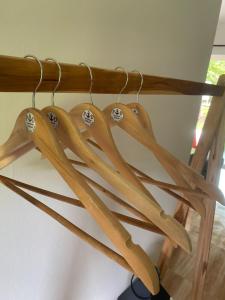 a bunch of wooden utensils hanging from a rack at PD RESORT Kohkood in Ko Kut
