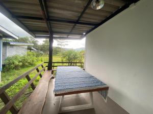 a bench on the side of a building with a window at PD RESORT Kohkood in Ko Kut