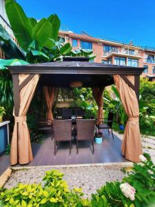 a gazebo with a table and chairs under it at 宣萱民宿 in Mile