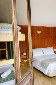 a bedroom with a bed and a bunk bed at Locanda del Lysjoch in Gressoney-la-Trinité