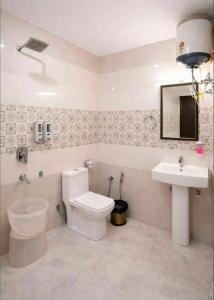 a bathroom with a toilet and a sink at The Woods Boho in Nainital +29 photos