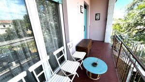 a balcony with two chairs and a table and a window at Appartamento ROMANA in Lugo