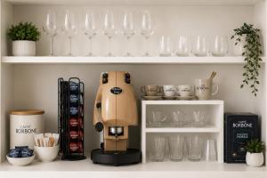 a coffee maker sitting on a shelf with glasses at ALBATROS Suites&Rooms in Naples