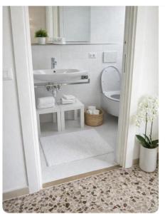 a white bathroom with a sink and a toilet at Sorrento life 3 in Sant'Agnello