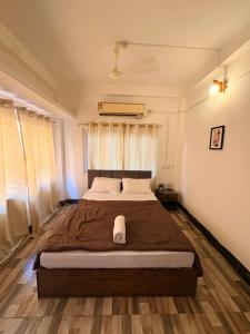 a bedroom with a large bed in front of a window at Heritage Home in Guwahati