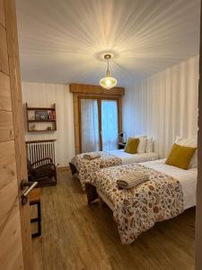 a hotel room with two beds and a couch at Chalet d'Honneur in Chamonix