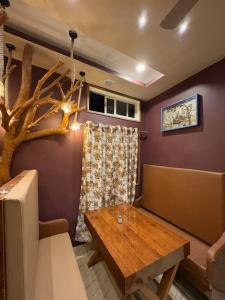 a living room with a table and a tree at Nahor Regency in Guwahati