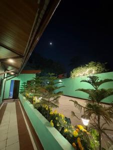 a building with a green wall with flowers and plants at Nahor Regency in Guwahati