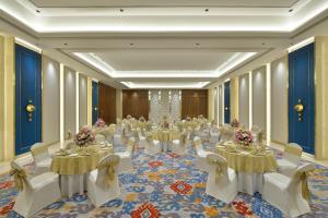 a large banquet hall with tables and white chairs at Boulevard9, Nadiad - IHCL SeleQtions in Nadiād +27 photos