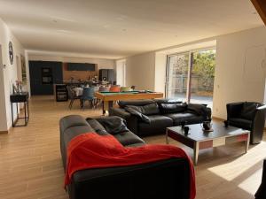 a living room with a couch and a table at Gite du haras in Erbrée