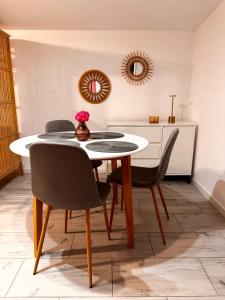 a dining room with a table and chairs at Domek pod Jabłonią in Barzowice +30 photos