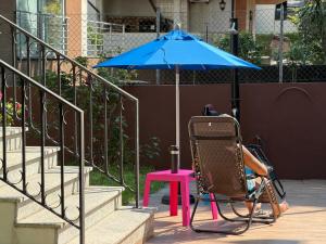 a person sitting in a chair under an umbrella at Casa Monsenhor in Braga