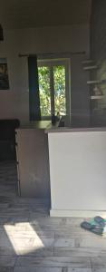a kitchen with a white counter and a window at Maison de ville in Roquemaure