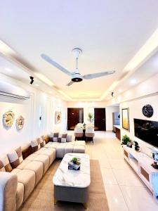 a large living room with a couch and a table at LMY Boutique Hotel Serviced Apartments Blue Area Islamabad in Islamabad