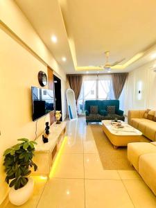 a living room with a couch and a tv at LMY Boutique Hotel Serviced Apartments Blue Area Islamabad in Islamabad