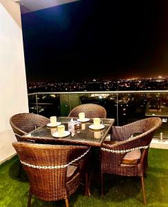 a table and chairs with a view of a city at LMY Boutique Hotel Serviced Apartments Blue Area Islamabad in Islamabad +25 photos