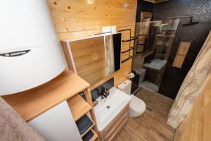 a small bathroom with a toilet and a sink at Brvnara Iva Kolašin Crna Gora in Selišta +29 photos