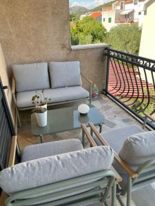 a patio with a couch and a table on a balcony at Agata in Šibenik