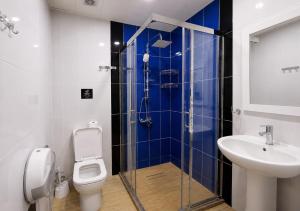 a bathroom with a shower and a toilet and a sink at Sahil Bay Hostel in Baku +44 photos