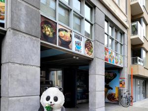 a stuffed panda bear sitting outside of a restaurant at kyoto b&b in Ostend