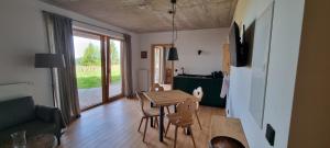 a living room with a wooden table and chairs at Bergmichlhof in Ragnitz