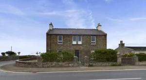 a brick house on the side of a road at Bignold Park View in Orkney