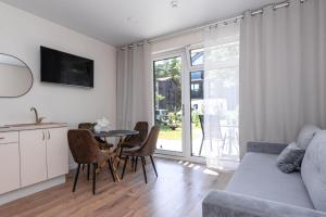 a kitchen and living room with a table and chairs at 2rest in Palanga