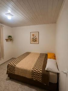 a bedroom with a bed in a white room at Destiny home in Curitiba +4 photos