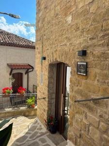 an entrance to a stone building with a door at La Stella del Viandante in Pietrapertosa