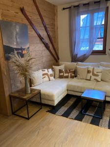 a living room with a couch and a table at L'Igloo - Balcon- Vue- Chic pres St-Lary in Vignec