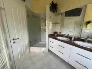 a bathroom with two sinks and a shower at LH Rooms in Absam
