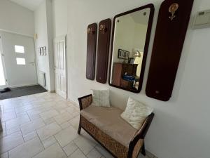 a mirror on a wall above a chair in a room at LH Rooms in Absam