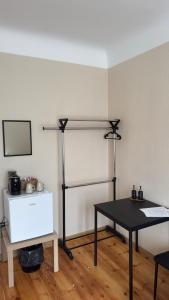 a room with a black table and a shelf at Smilšu ielas Hostelis in Valmiera