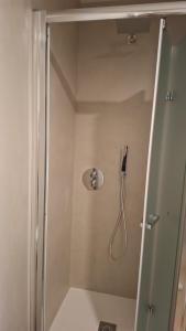 a shower in a bathroom with a phone on the wall at Brizo in Termoli