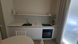 a small kitchen with a sink and a stove at Brizo in Termoli