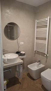 a bathroom with a sink and a toilet and a mirror at Brizo in Termoli +2 photos