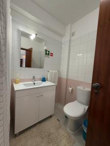 a bathroom with a toilet and a sink and a mirror at Casa Nau B in Armação de Pêra +10 photos
