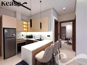 a kitchen with a white counter and chairs in it at Kease Hittin S-18 Latest Development ZA44 in Riyadh