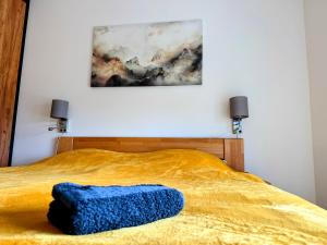 a blue pillow on a bed in a bedroom at Apartmán Valašský Eden in Horní Bečva