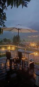 a table and two chairs with an umbrella at สะปันฮิลล์ Sapan Hill in Ban Huai Ti