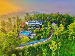 an aerial view of a house in the forest at Villa Tesori Homestay Wayanad in Meppādi