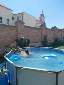 a couple of people swimming in a hot tub at U svaté Rozálie in Horní Věstonice