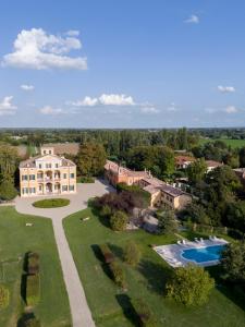 an aerial view of a large house with a pool at Villa Simonetta in Parma