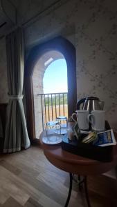 a table in a room with a view of a balcony at Hotel Villa Fanti in Loreto