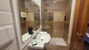 a bathroom with a sink and a shower at Hotel Villa Fanti in Loreto